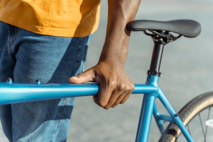 Un homme qui tient son vélo électrique bleu