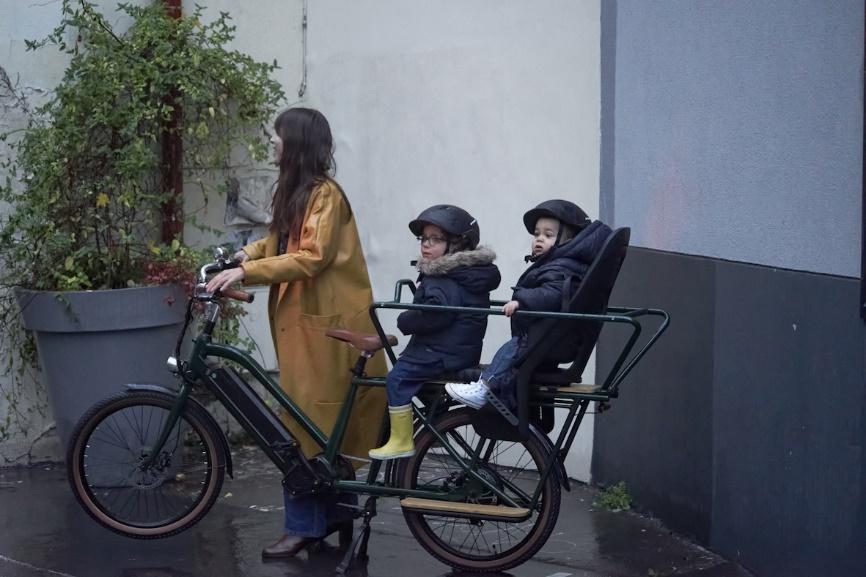 Une mère et ses enfants sur un vélo cargo électrique