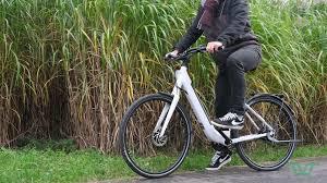 Un homme sur un vélo électrique blanc dans des hautes herbes